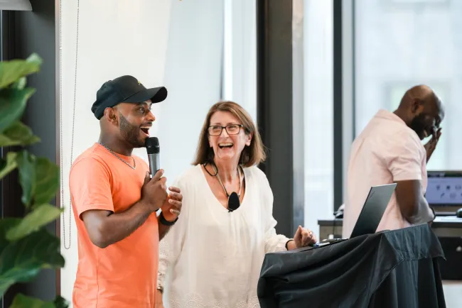 Two people presenting at a staff meeting